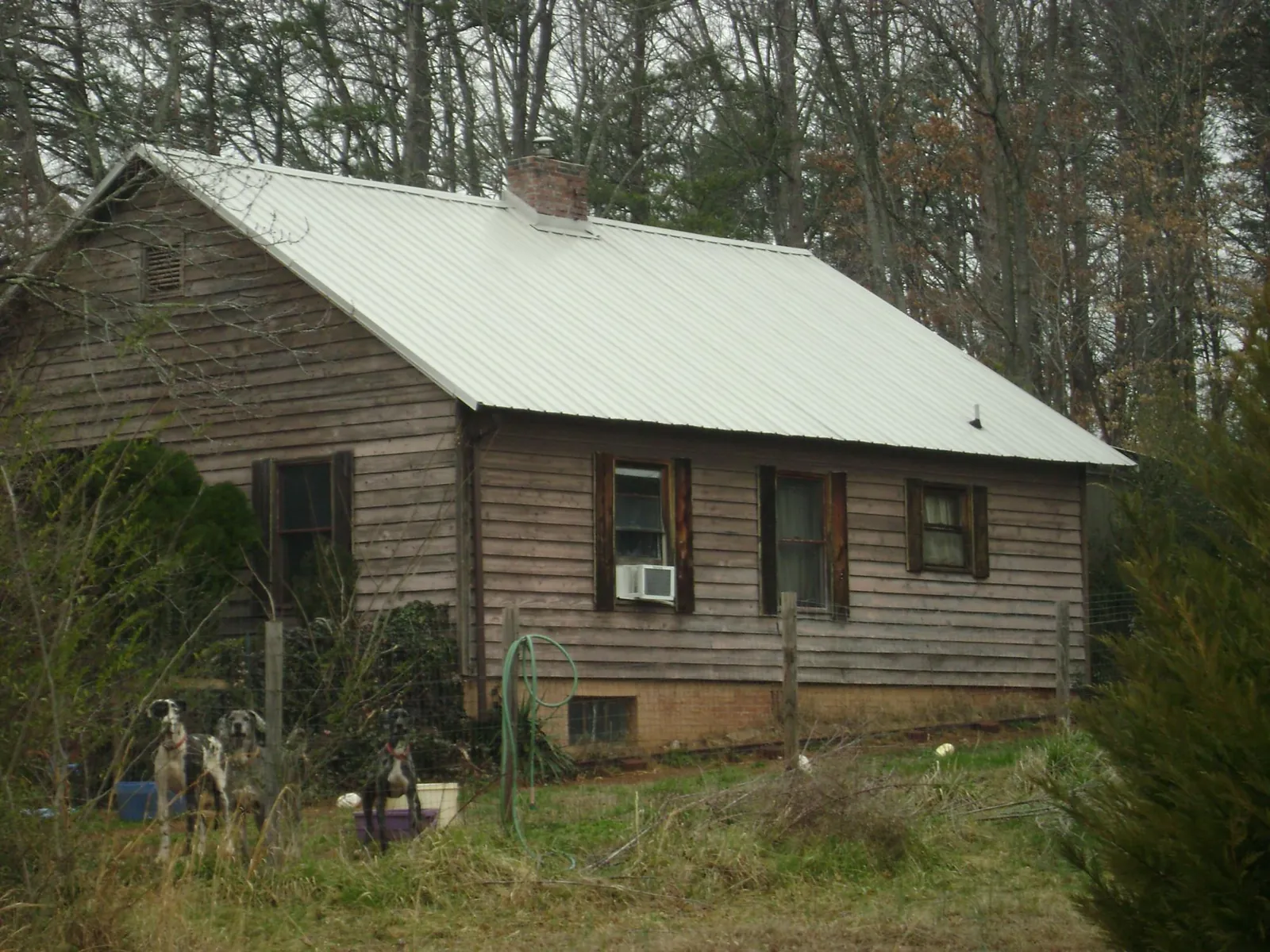White metal roof on an old wood sided farmhouse, from a Metal Roof Installation job in Seven Valleys